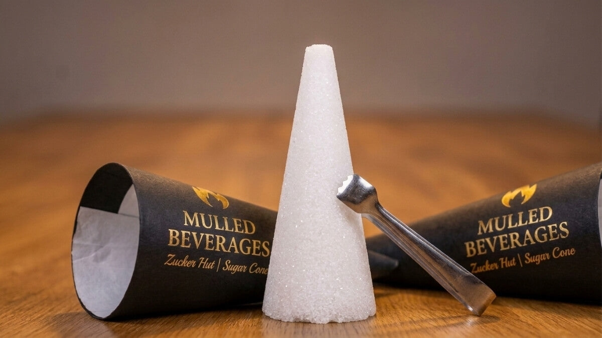 Mulled Beverages Zucker Hut sugar cone with tongs beside branded packaging for Feuerzangenbowle